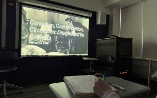 Students review a Dracula presentation slide in a UAlbany Honors College course.