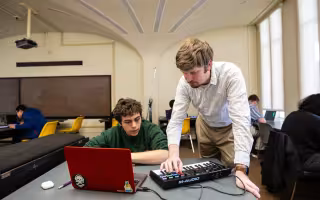 Thomas Wilson uses a MIDI keyboard to interact with a student in his game design course.
