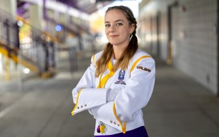 Grace Augenstern stands with her arms crossed in the Tom & Mary Casey Stadium concourse.