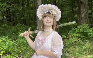Sophie Breunig holds up a sword used as part of the UAlbany Living History Club.