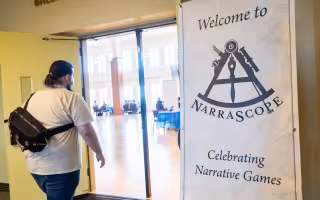 An attendee of NarraScope 2026 walks into the Campus Ballroom.