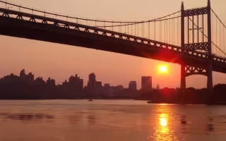 A heatwave sunset under a bridge in Astoria Park.