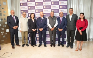 Leadership from UAlbany and RISM stand in front of a step and repeat with the logos of both universities.