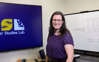 Elyse Zavar, Director of the Information Science PhD Program, stands inside CEHC's Disaster Studies Lab.