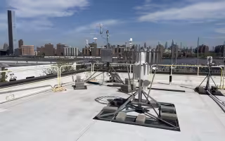 A Mesonet site with the New York City skyline behind it.