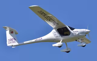A small plane with 100 percent electric written on the wings.