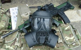 Photo of gas mask and rifle.