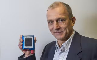 Chemist Igor Lednev displays a portable Raman spectrometer.
