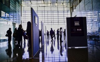 People looking at photos during the 2019 Photovoice event.