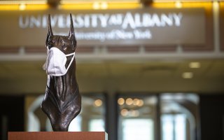 The bust of Damien in the CC Lobby wears a white mask