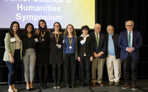 UAlbany organizers stand with student finalists at the Upstate New York Junior Science and Humanities Symposium award ceremony.