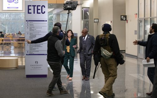 Gov. Hochul and Al Roker walk through the ETEC atrium with the TODAY Show production crew.