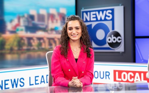 Jordan Due sits at the NEWS10 ABC anchor desk in a pink blazer.