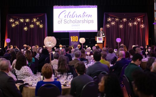 A large group of people sitting at tables for the Celebration of Scholarship dinner.