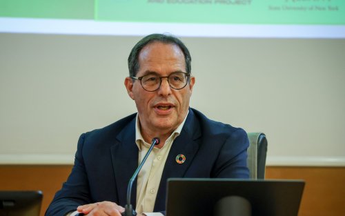 Dr. Aaron Benavot speaking at a conference