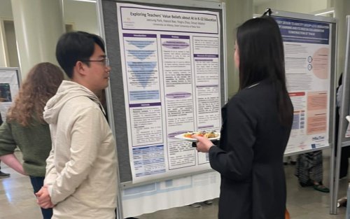 individuals looking at a research poster