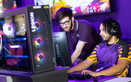 Henry Scholl, UAlbany Esports student program coordinator, views a teammates' gaming PC inside the UAlbany Esports Arena. 