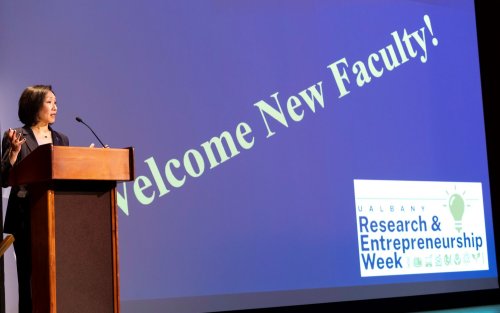 UAlbany Provost Carol Kim stands at lecturn to introduce the University's new faculty