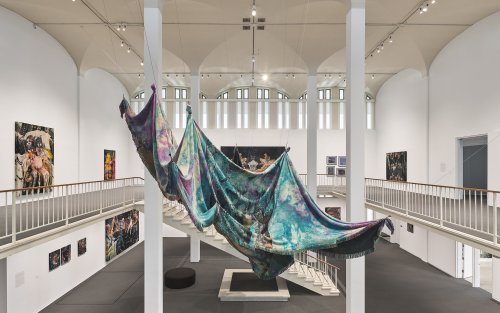 Large shrouds hanging from the ceiling of the museum.
