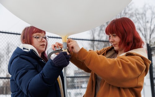 UAlbany students prepare a weather balloon for launch from the ETEC parking lot.