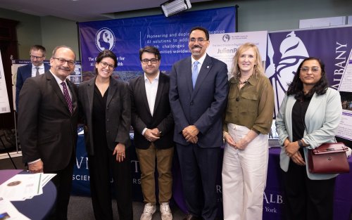 UAlbany President Havidán Rodríguez, SUNY Chancellor John B. King Jr., and four other individuals standing next to one another for a picture.