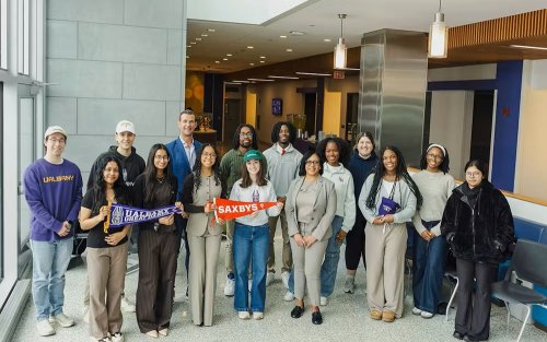 Group of students and faculty stand with Saxbys staff to celebrate the new student-led cafe coming in the fall