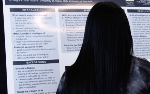 Undergraduate student stands in front of research poster from WCI AI & Writing Fair