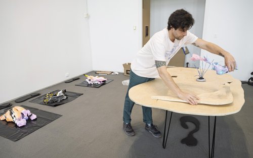 Artist Ira Marcks installing sculpture