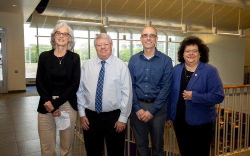 UAlbany faculty Elaine Salisbury, Kevin Knuth and Ryan Torn stand with College of Arts and Sciences Dean Jeanette Altarriba indoors.