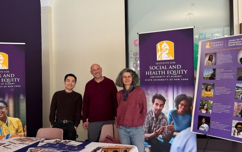 An image of the three individuals from ISHE at a booth for the UAlbany Showcase 2026.