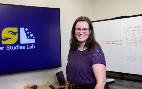 Elyse Zavar, Director of the Information Science PhD Program, stands inside CEHC's Disaster Studies Lab.