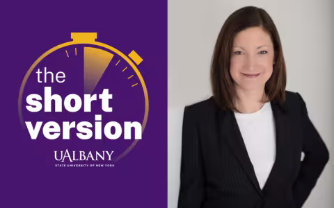 A split image featuring a smiling portrait of woman in a dark blazer on the right and a yellow stop watch logo against a purple background with the words "The Short Version" on the left.