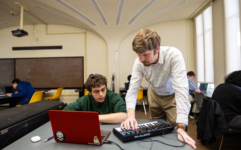 Thomas Wilson uses a MIDI keyboard to interact with a student in his game design course.