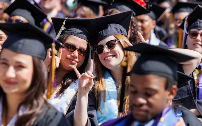 a croud of graduates wearing mortarboards