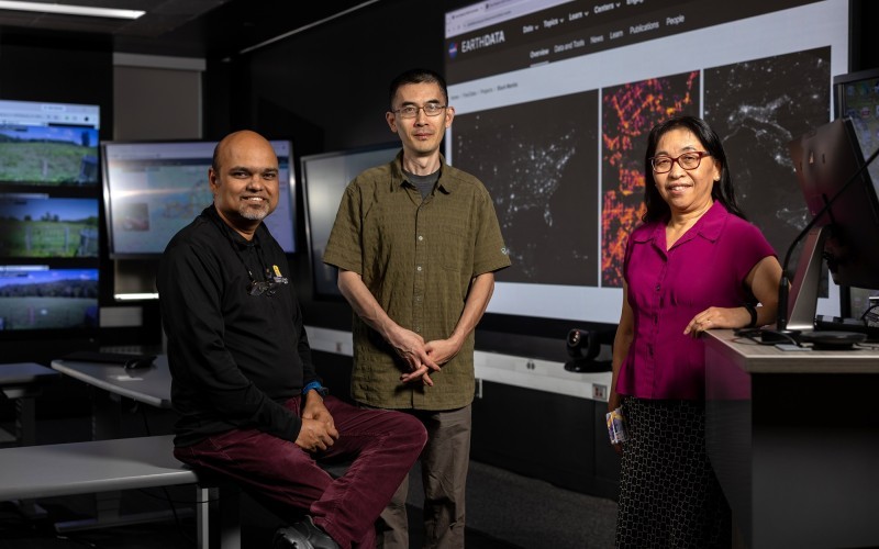 UAlbany researchers stand in front of screens inside the xCITE Laboratory at ETEC.