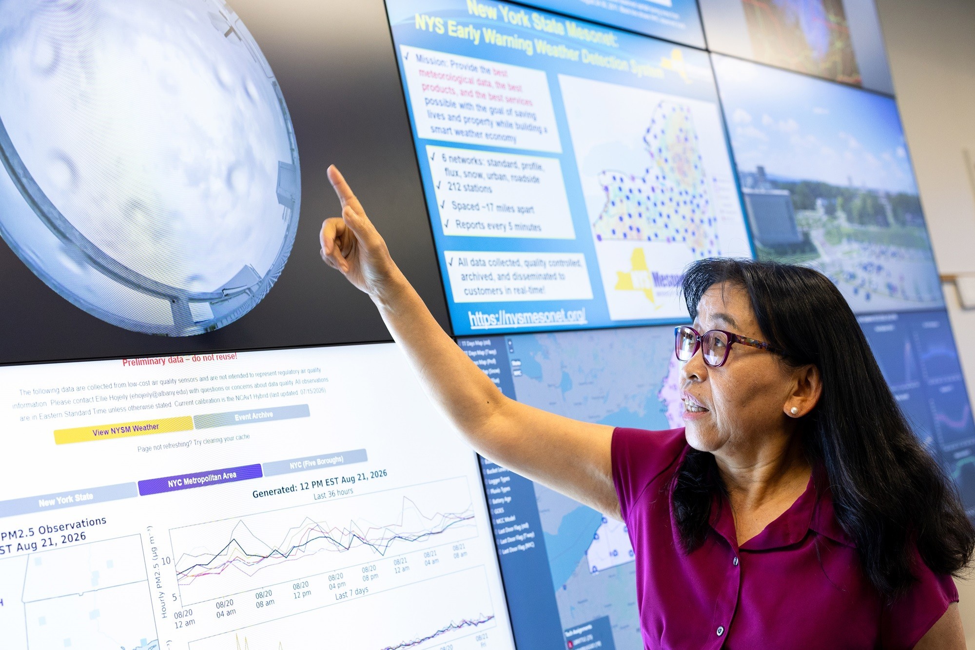 June Wang points to a birds eye camera view of a New York State Mesonet site.