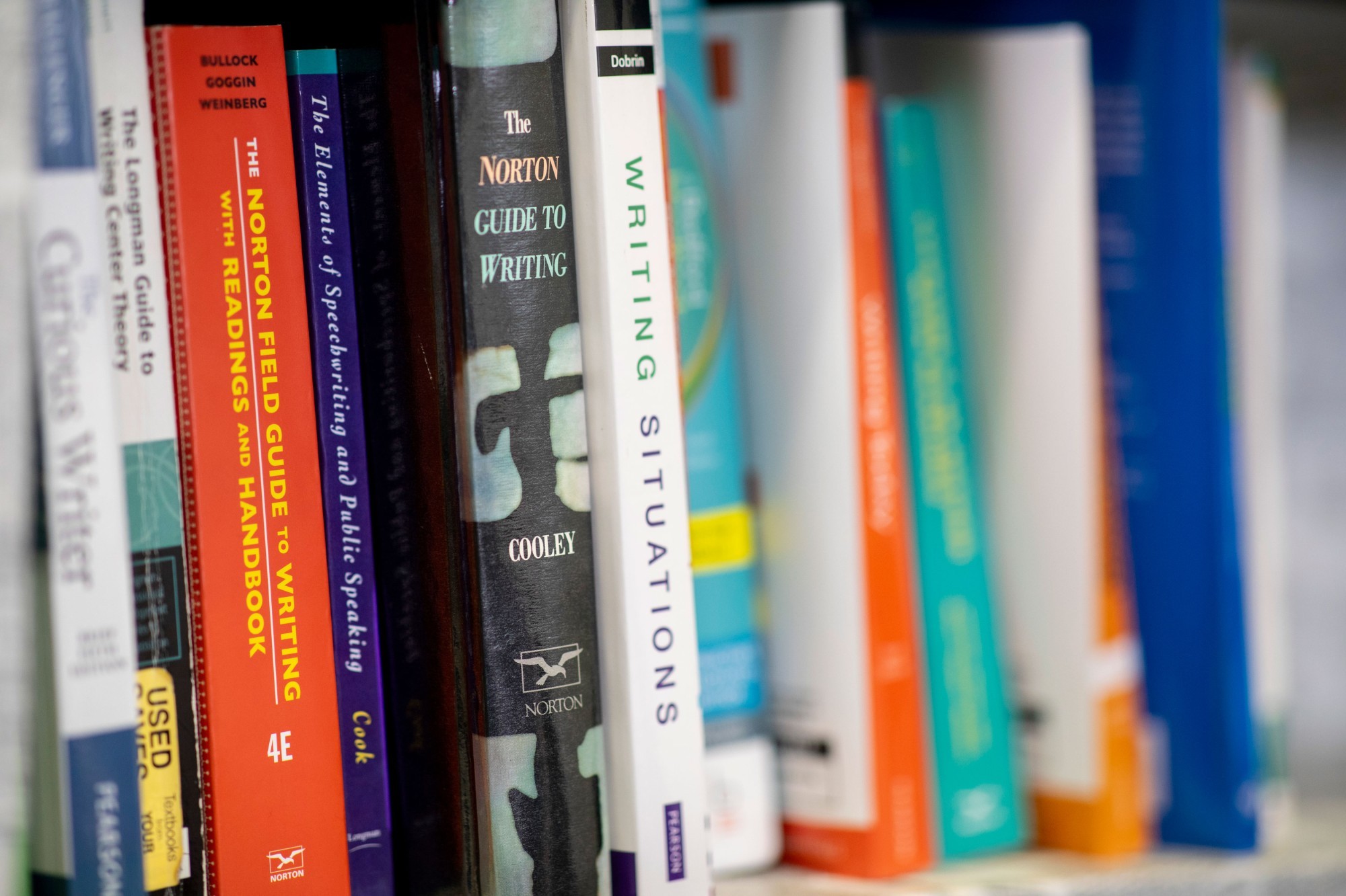 An image of a closeup of books on a shelf.
