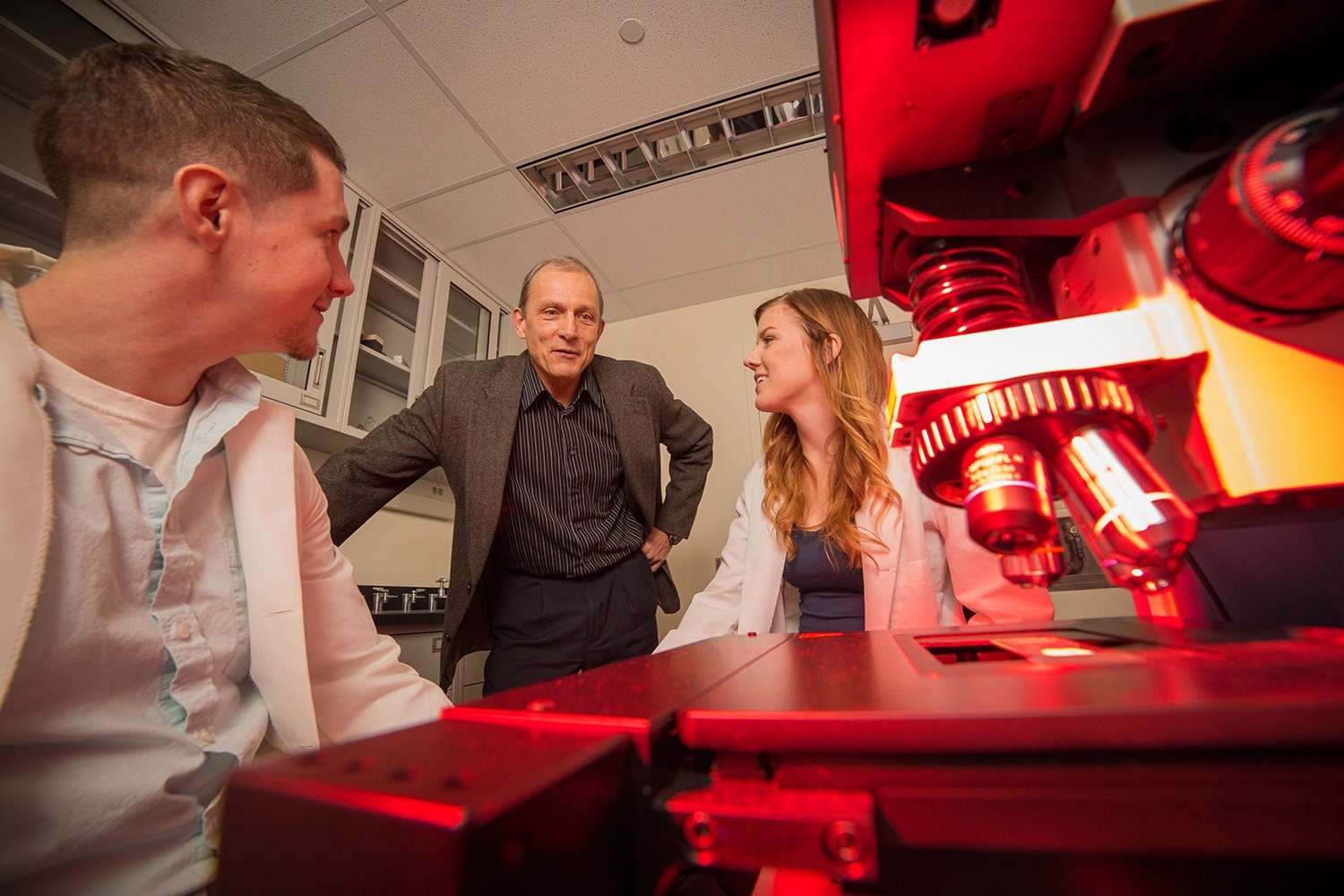 Two students working with Professor Igor Lednev in a research lab.