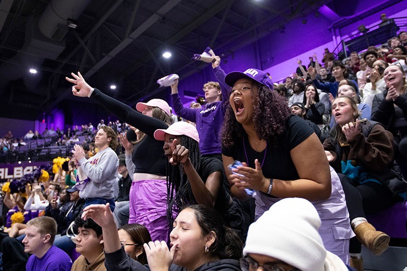 Students cheering at a UAlbany basketball game.