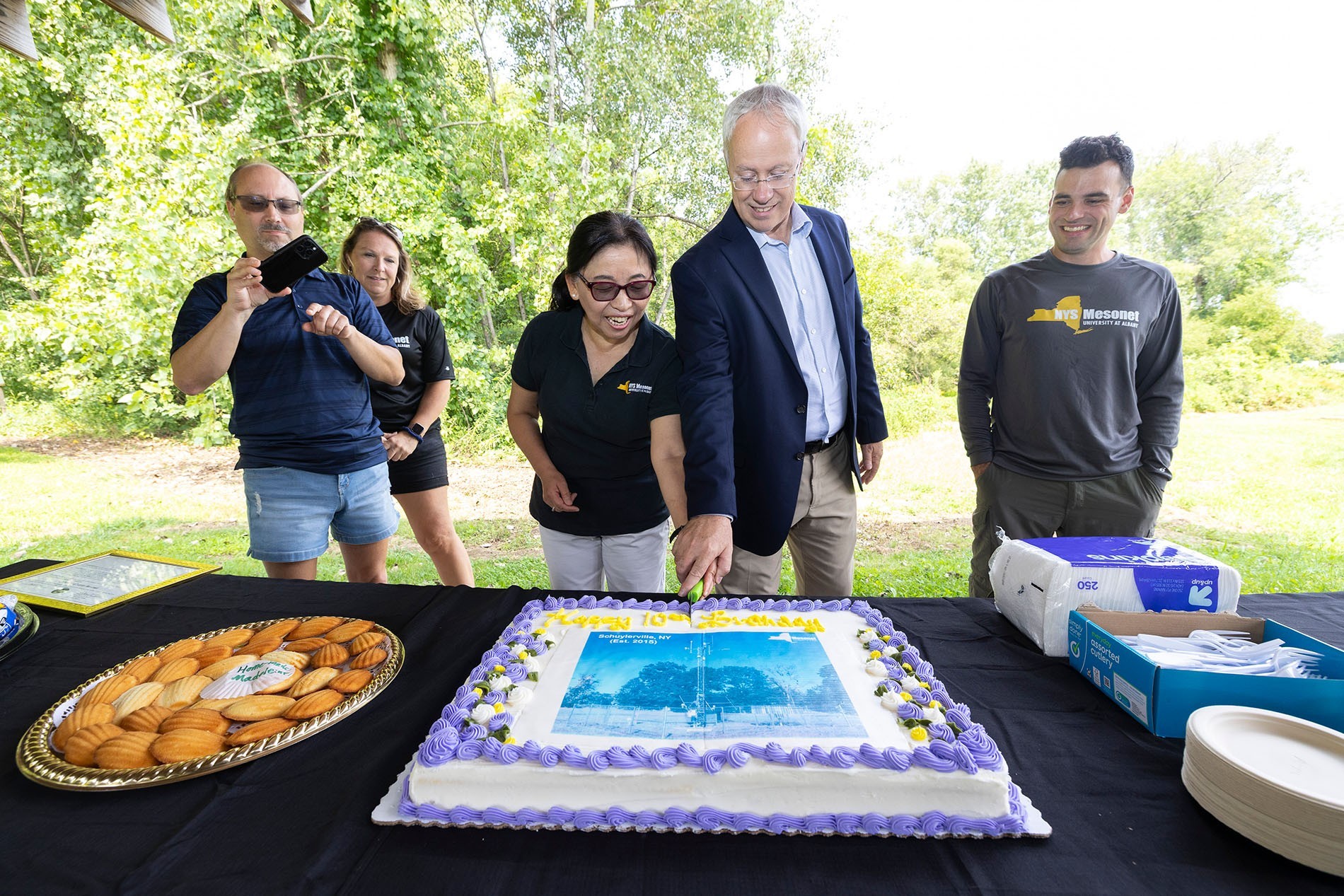 Mesonet leaders cut a cake to celebrate the Schuylerville site's 10th birthday.