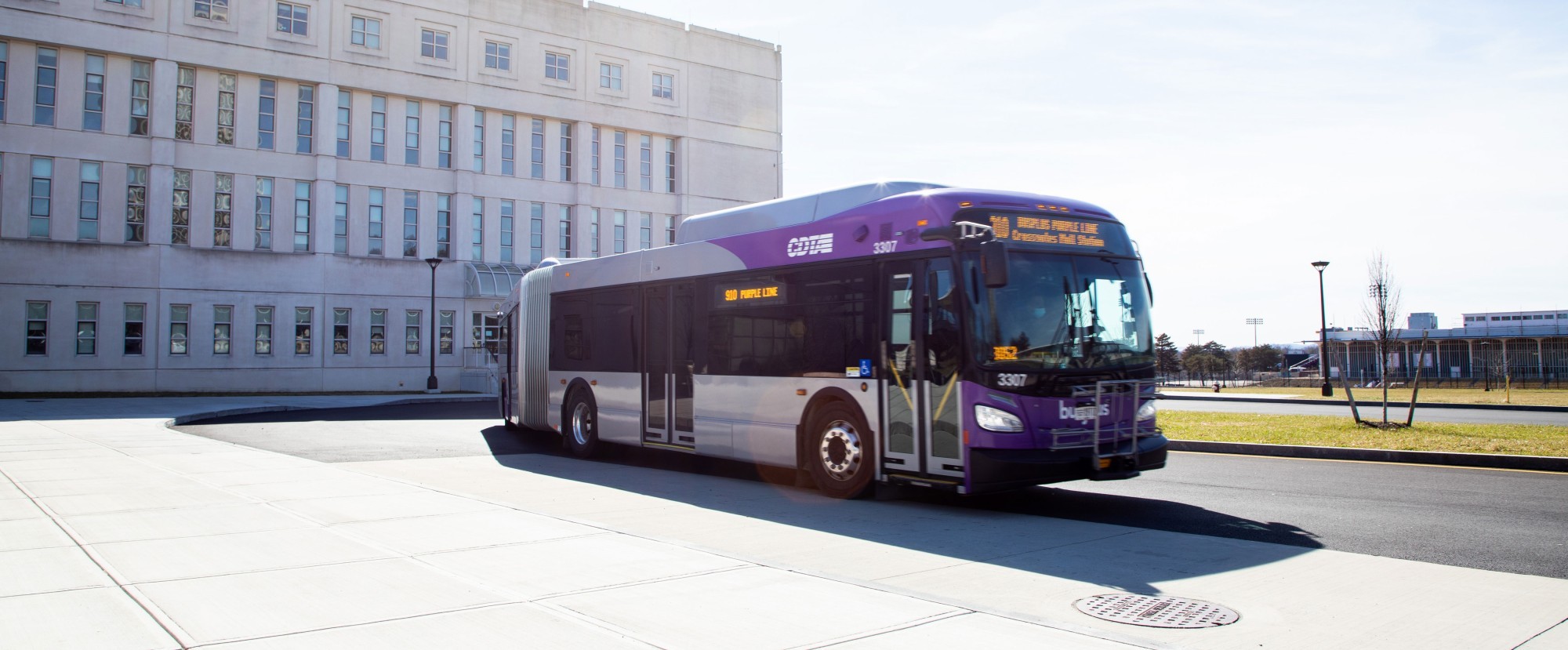 A CDTA bus pulls up to a stop outside the Science Library on UAlbany's Uptown Campus.