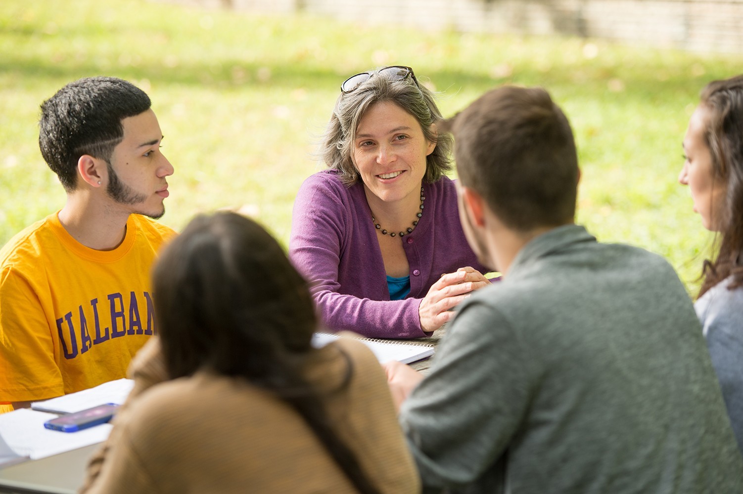 A faculty member teaches students outside