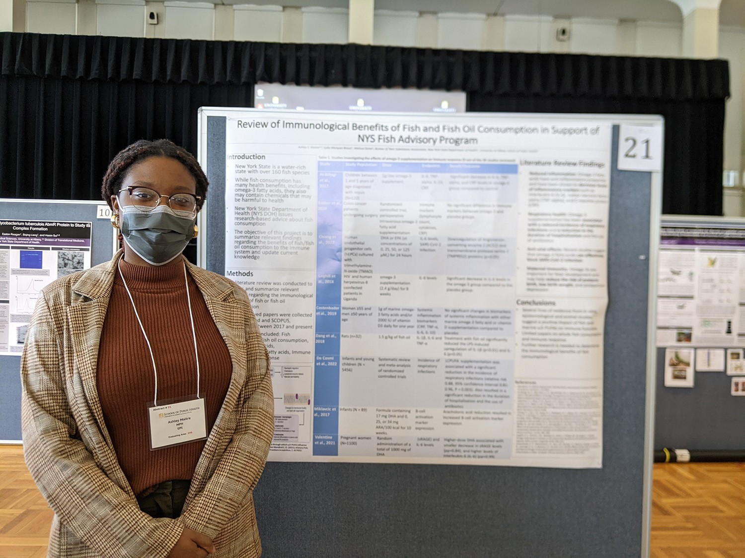 Ashley stands next to her poster.