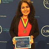 Stuti Misra holding a SUNY award