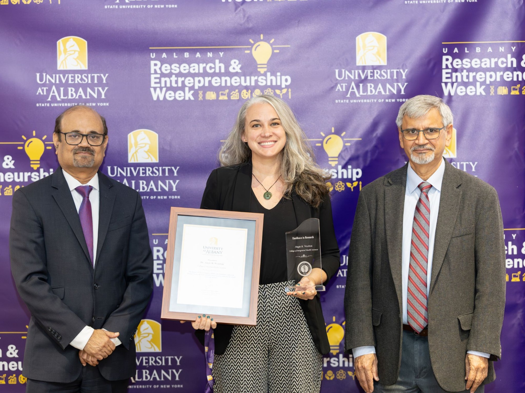 Angie Wootton holds her award for her research.
