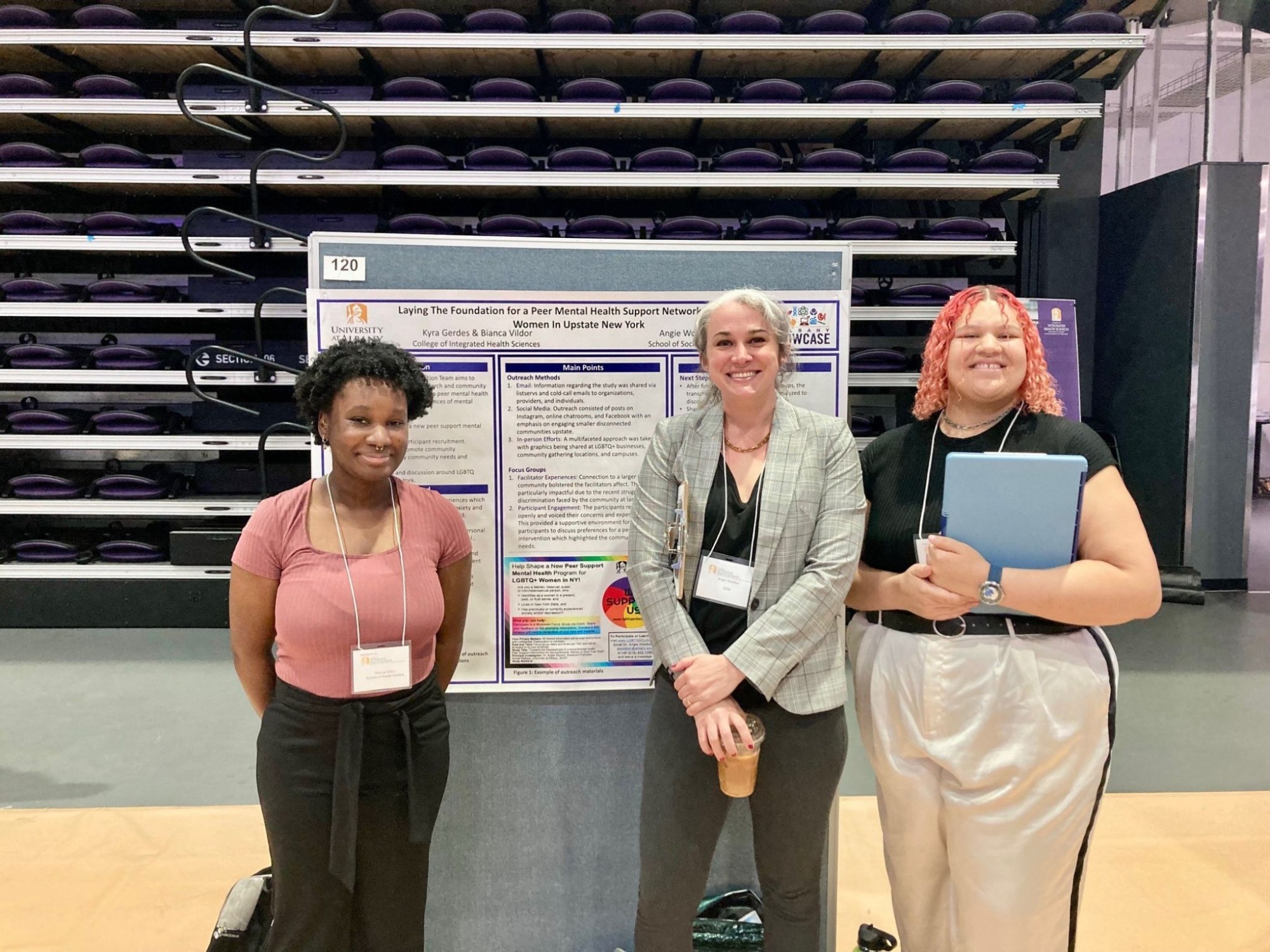 Kyra Gerdes, Forrest Vildor, and Angie Wootton stand in front of an academic poster.