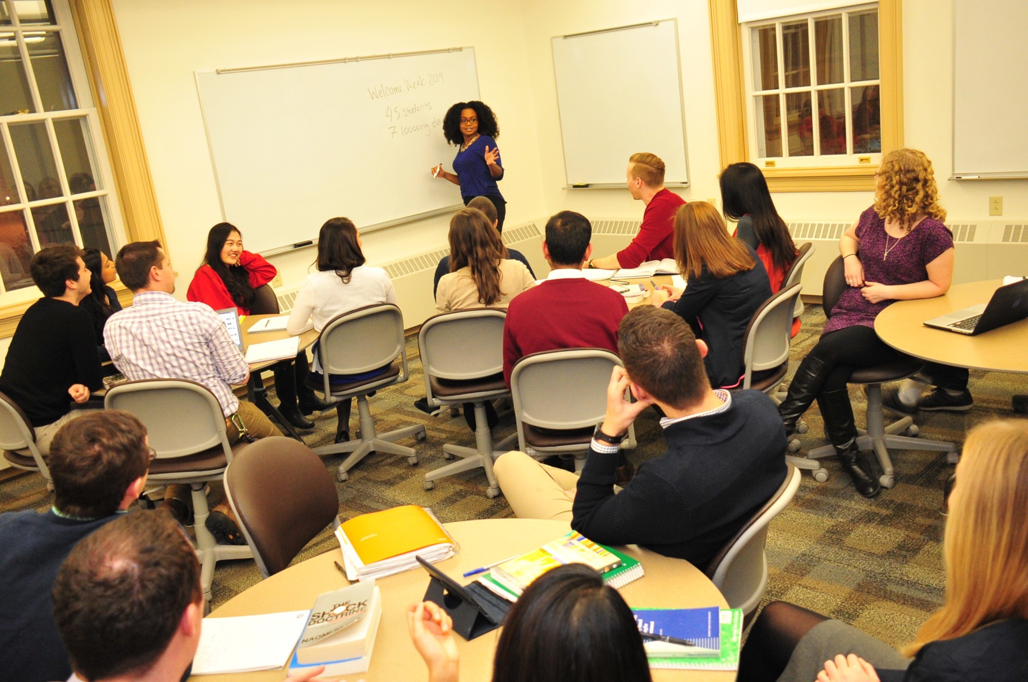 UAlbany Classroom with teacher at front of classroom and students' backs to us.