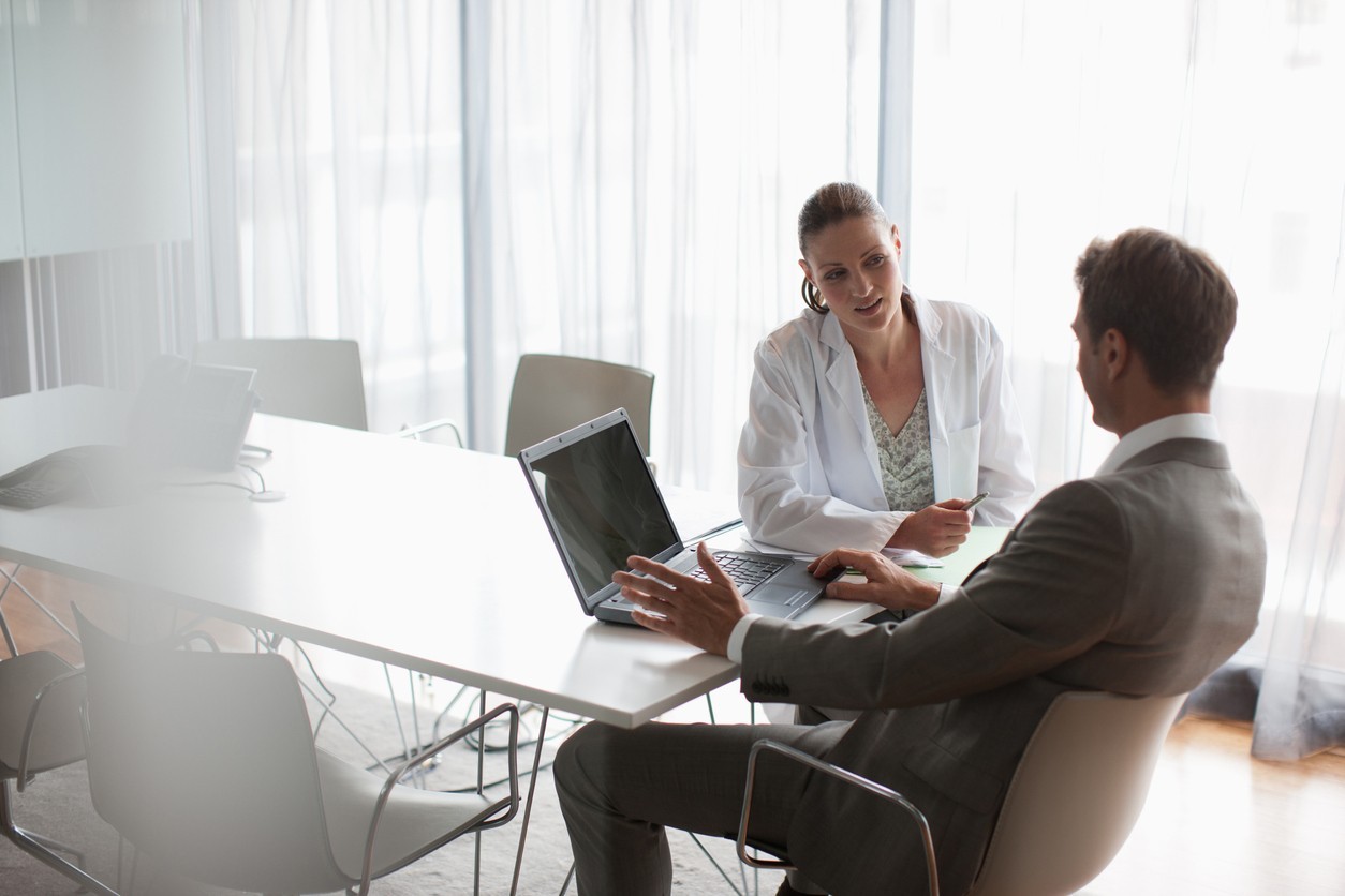 Businessman working with scientist in conference room