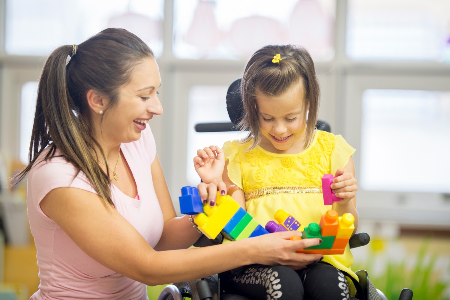 A teacher working with a special needs student.