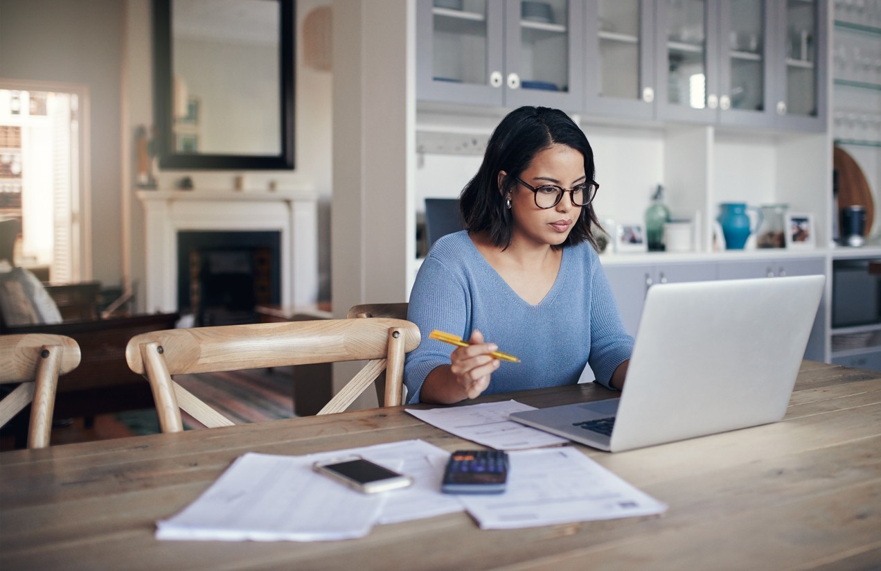Woman working on a laptop in a home office